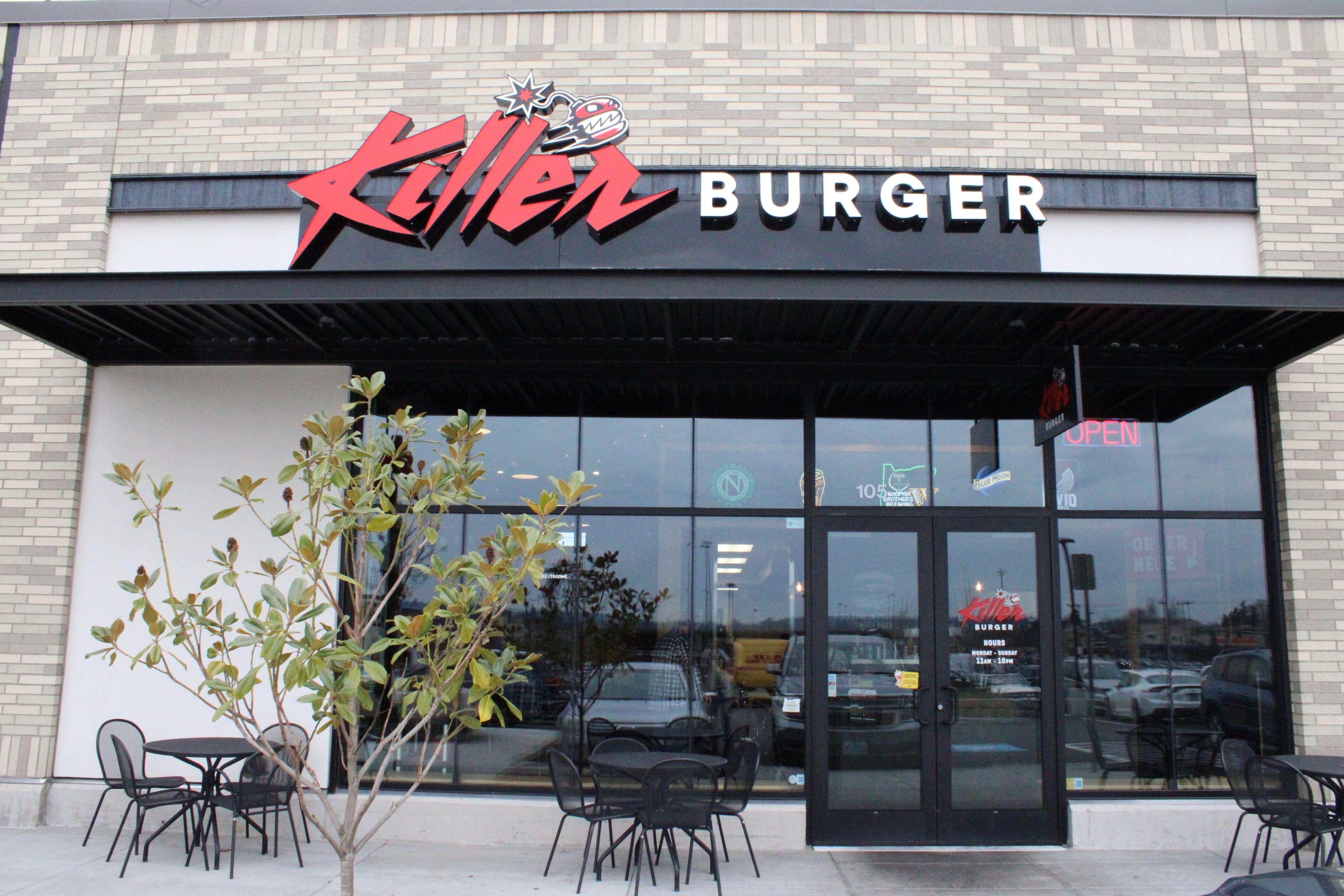 Killer Burger Cedar Hills — storefront exterior with black awning, patio seating, and red signage