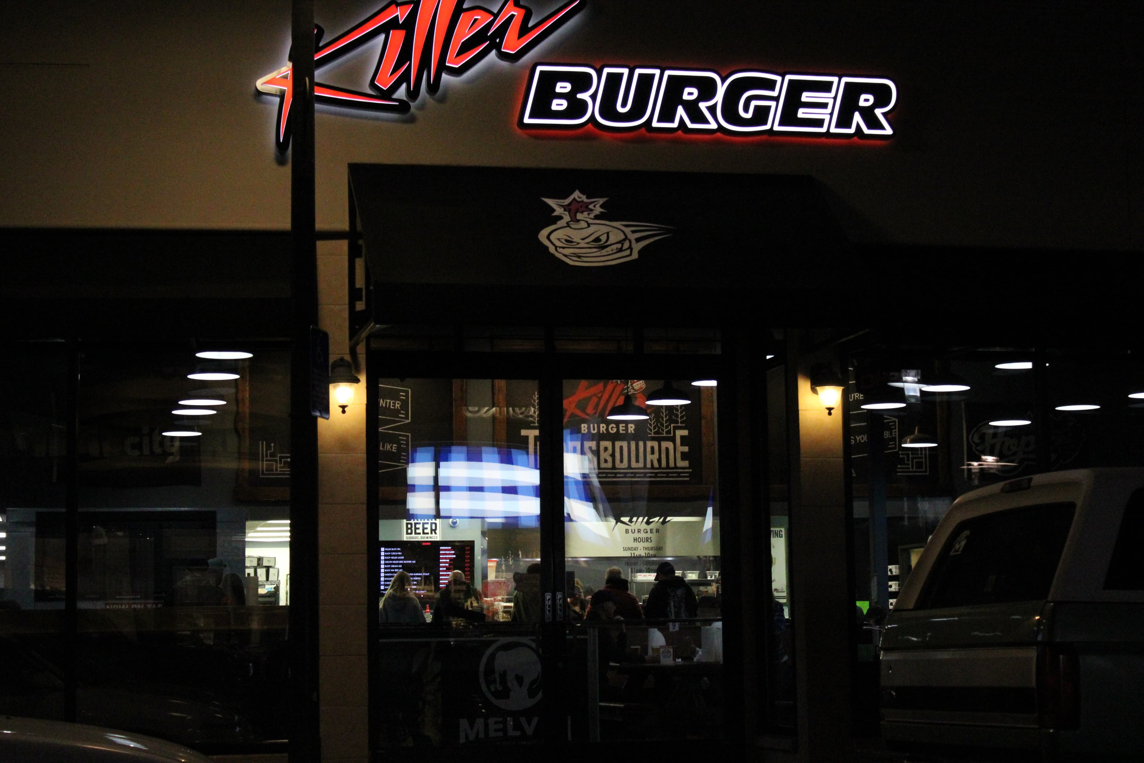 Killer Burger Tanasbourne — storefront entrance at night with illuminated signage